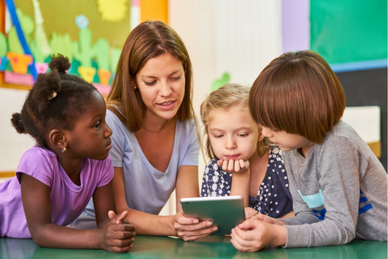 Teacher guiding kids, USA